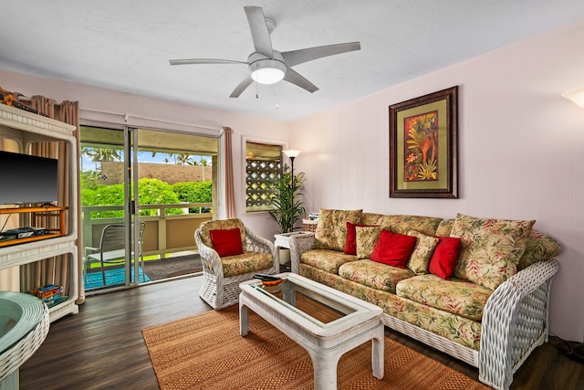 living room with dark hardwood / wood-style floors and ceiling fan