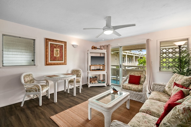 living room featuring ceiling fan and dark hardwood / wood-style flooring