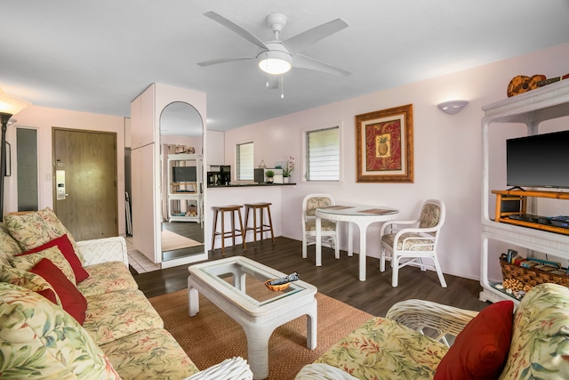 living room with ceiling fan and dark hardwood / wood-style floors