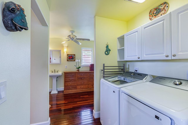 washroom featuring ceiling fan, sink, cabinets, washing machine and dryer, and dark hardwood / wood-style floors