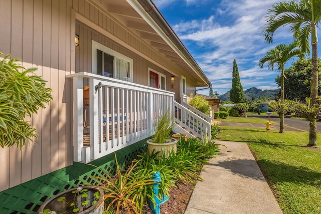 view of side of home featuring a mountain view and a porch