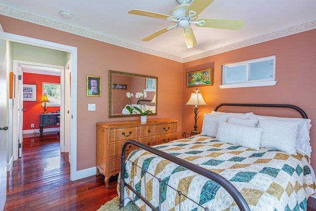 bedroom with dark hardwood / wood-style floors, ceiling fan, and ornamental molding