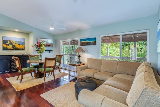 living room with dark hardwood / wood-style floors, ceiling fan, a wealth of natural light, and vaulted ceiling