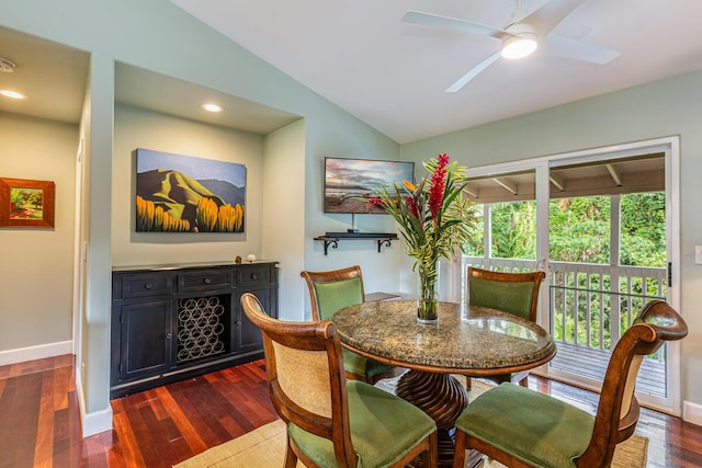 dining room with ceiling fan, dark hardwood / wood-style floors, and lofted ceiling