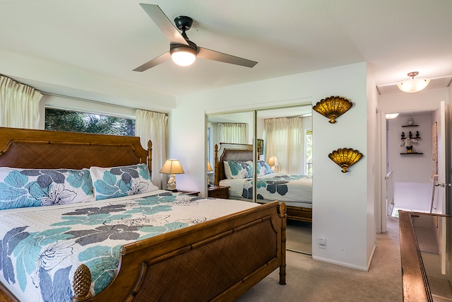 carpeted bedroom featuring ceiling fan and a closet