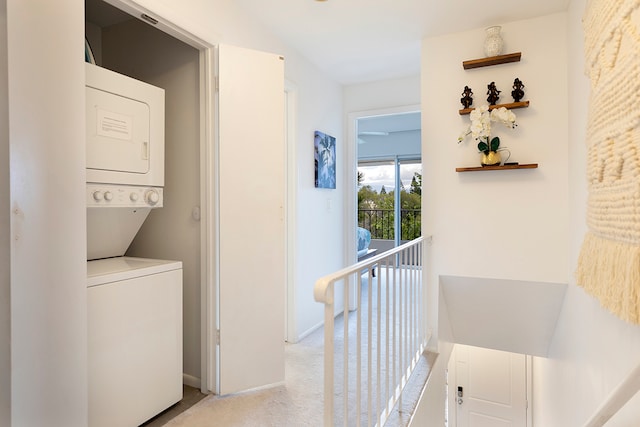 washroom with stacked washer and dryer and light colored carpet