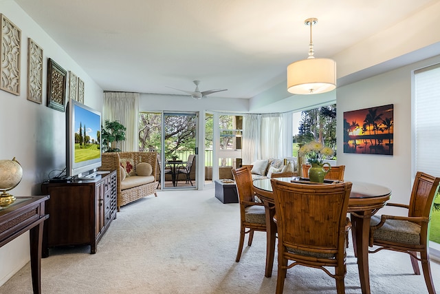 dining area featuring light carpet and ceiling fan