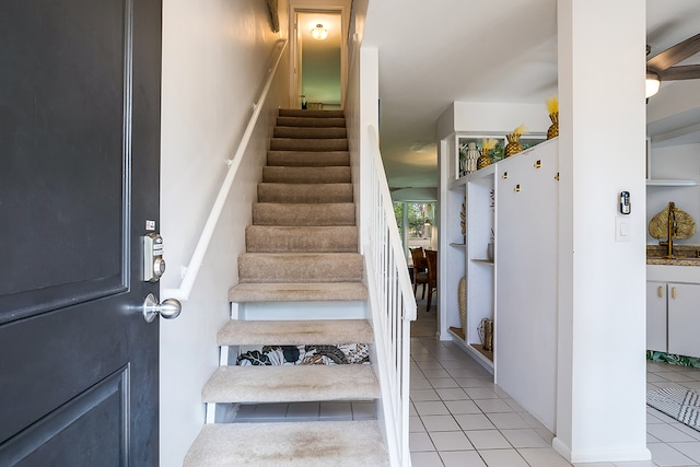 staircase featuring tile patterned floors