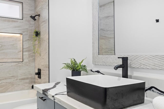 full bathroom with tiled shower / bath combo, vanity, and toilet