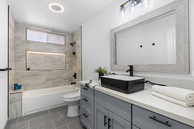 full bathroom with tiled shower / bath, vanity, tile patterned flooring, and toilet