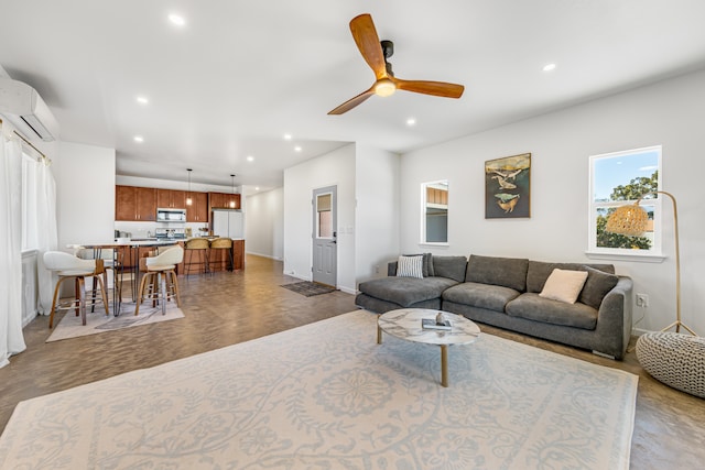 living room with ceiling fan, parquet floors, and a wall mounted AC