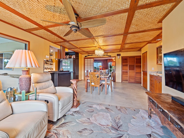 tiled living room featuring ceiling fan with notable chandelier and coffered ceiling