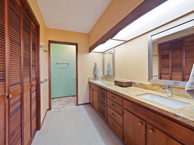 bathroom with a textured ceiling and vanity