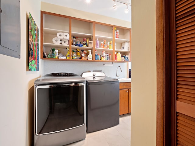 clothes washing area with independent washer and dryer, light tile patterned floors, cabinets, electric panel, and sink