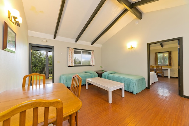 dining area with beam ceiling, high vaulted ceiling, and wood-type flooring