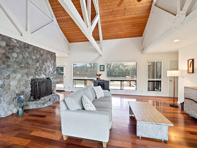 living room with a fireplace, dark hardwood / wood-style floors, and high vaulted ceiling