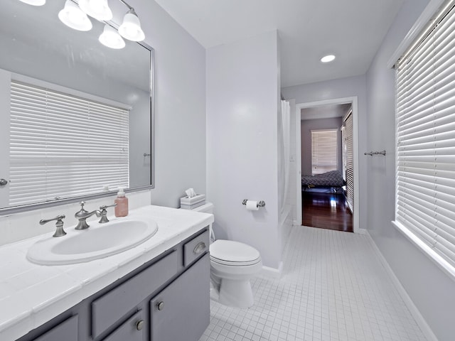 bathroom with vanity, toilet, and tile patterned floors