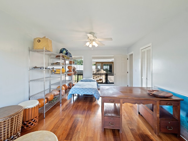 bedroom with wood-type flooring, a closet, and ceiling fan