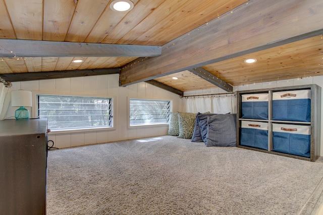 unfurnished living room featuring vaulted ceiling with beams, wood ceiling, and carpet flooring