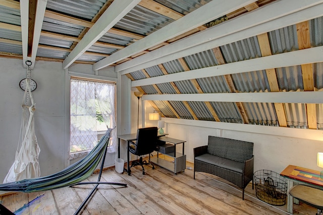 sitting room featuring vaulted ceiling with beams and hardwood / wood-style floors