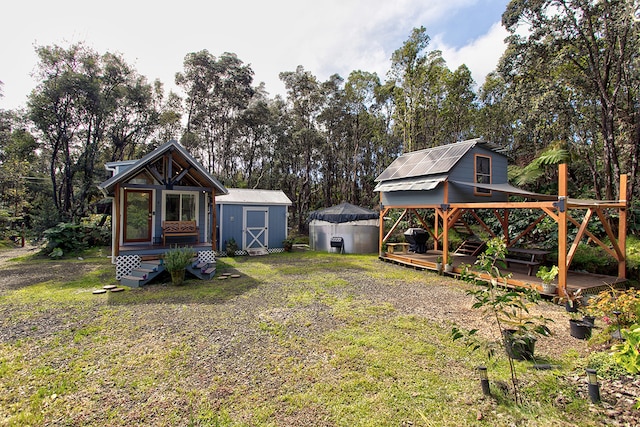 view of yard featuring a storage shed and a deck