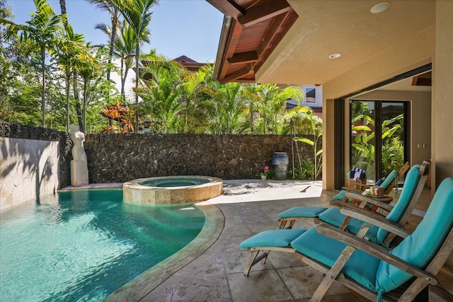 view of swimming pool featuring a patio and an in ground hot tub