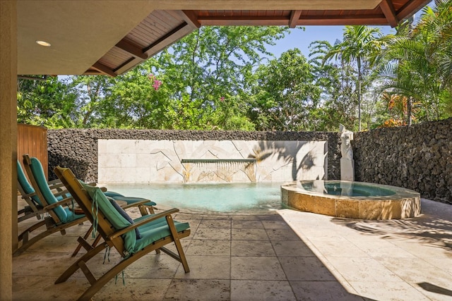 view of patio featuring pool water feature and an in ground hot tub