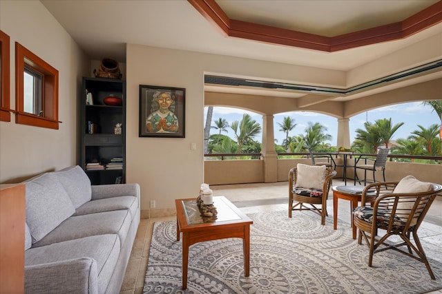 interior space featuring light tile patterned flooring and a raised ceiling