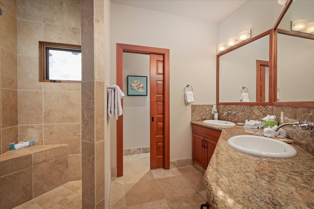 bathroom with vanity and tiled shower