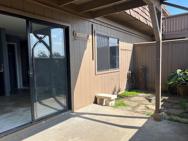 view of exterior entry with a patio area