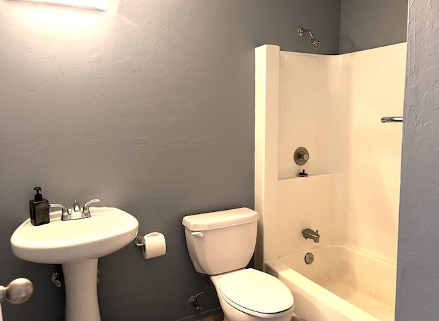 bathroom featuring shower / tub combination and toilet