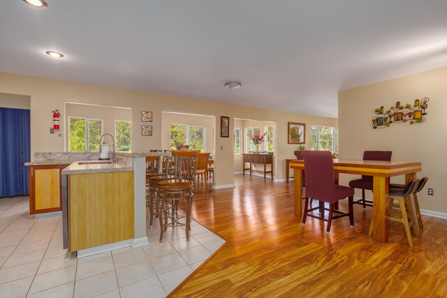 dining room with light wood-type flooring and sink