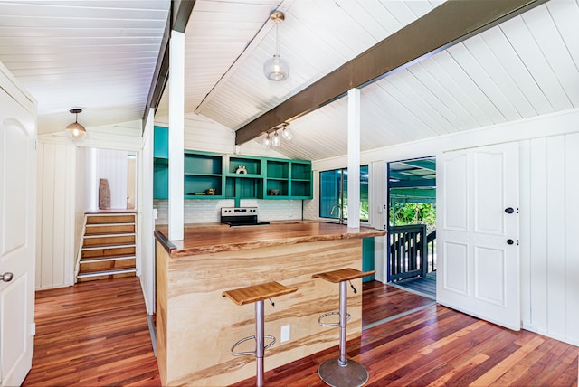 kitchen with lofted ceiling with beams, dark hardwood / wood-style floors, hanging light fixtures, and range with electric cooktop