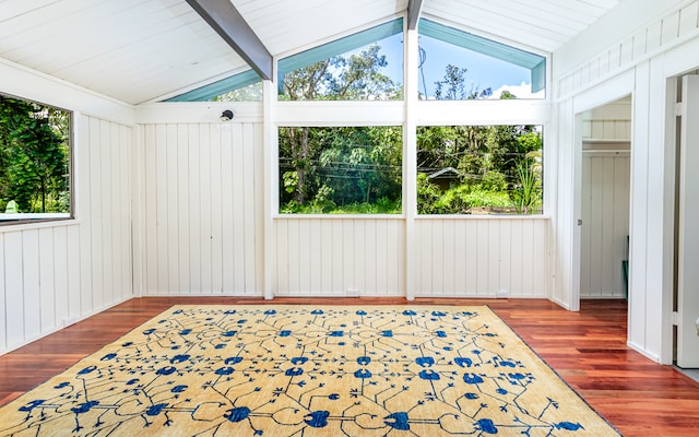 sunroom / solarium featuring a wealth of natural light and vaulted ceiling with beams