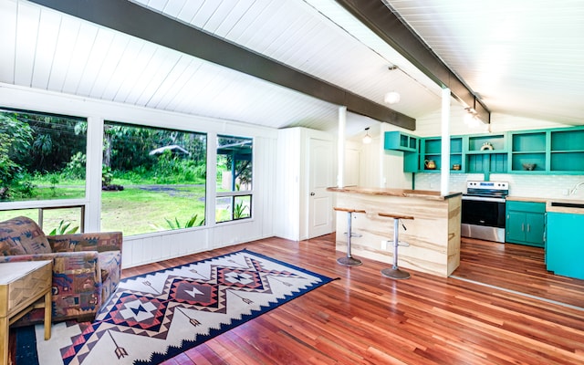 interior space with vaulted ceiling with beams and hardwood / wood-style flooring