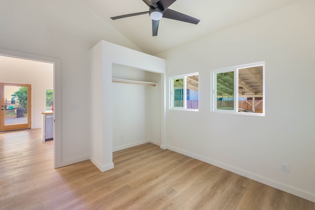 unfurnished bedroom featuring light hardwood / wood-style floors, lofted ceiling, ceiling fan, and a closet