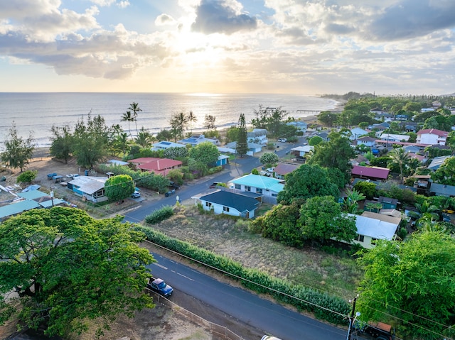 aerial view at dusk featuring a water view