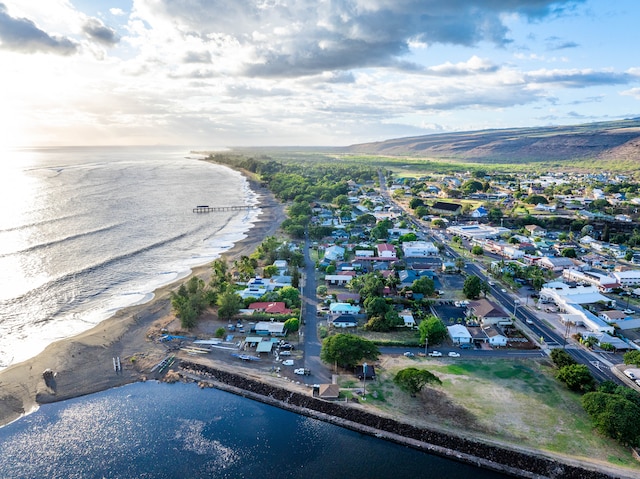 drone / aerial view featuring a beach view and a water view