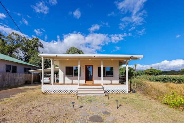 view of front of house with a carport and covered porch