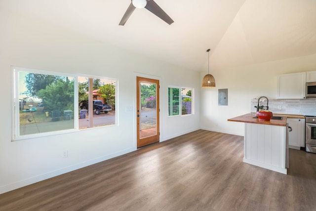 kitchen with white cabinets, plenty of natural light, butcher block countertops, and hanging light fixtures