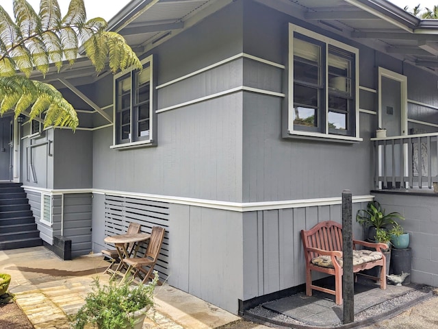 view of side of property with covered porch