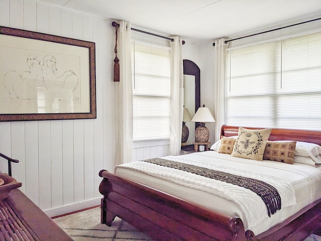 bedroom with wood walls