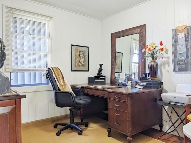 home office with light carpet and wooden walls