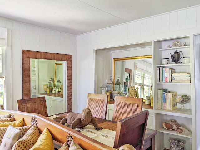 dining space featuring wood walls