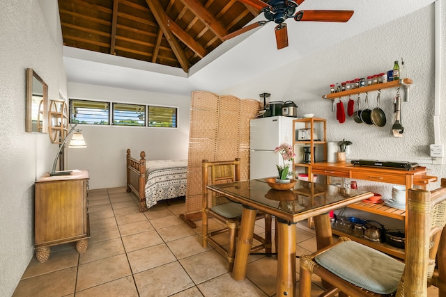 kitchen with light tile patterned flooring, beamed ceiling, white refrigerator, ceiling fan, and wooden ceiling