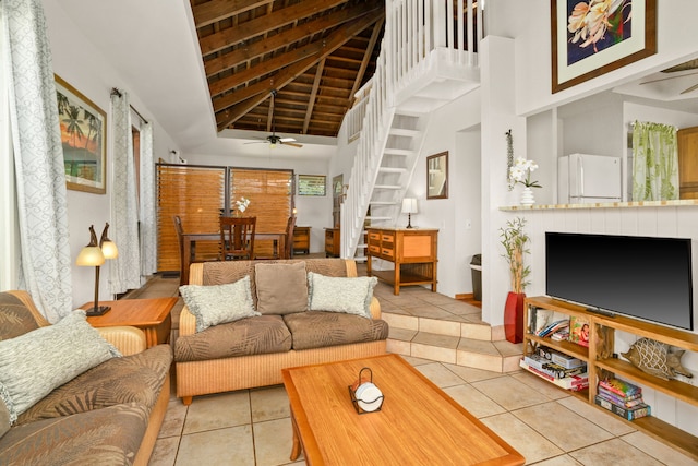 tiled living room featuring a high ceiling and ceiling fan