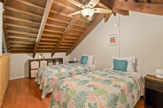 bedroom featuring vaulted ceiling with beams, hardwood / wood-style floors, wooden ceiling, and ceiling fan