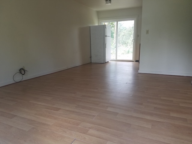 spare room featuring light wood-type flooring