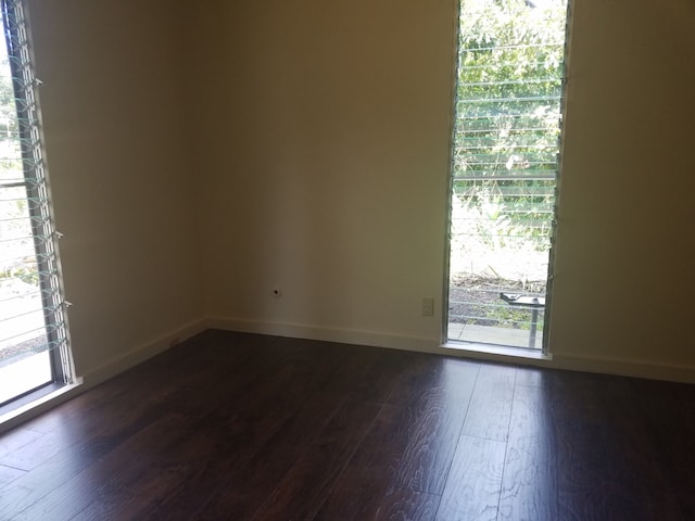 spare room with dark wood-type flooring