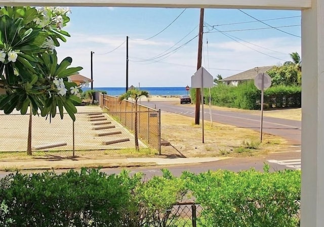 view of yard with fence and a water view